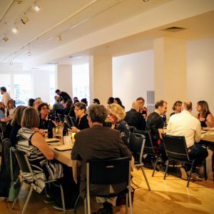 People eating in the art gallery for the wine and dine event, Paired Provisions, at The Arts Center of The Capital Region